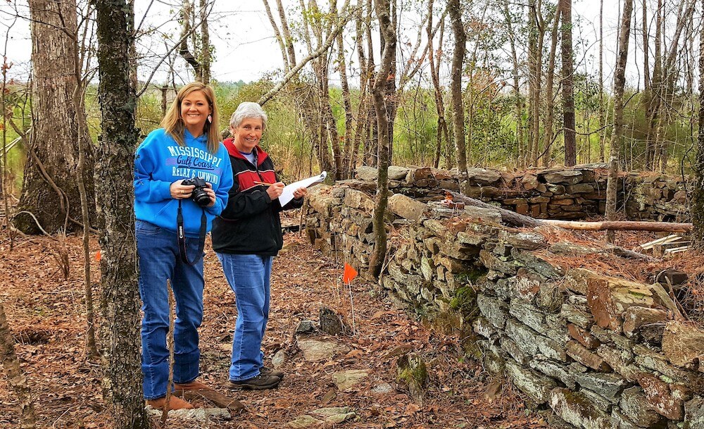 Misty and Susanne standing among trees.